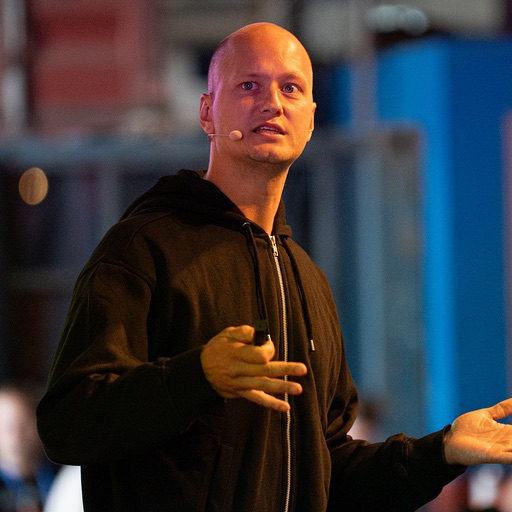 Isak Berglind on stage, mid-talk